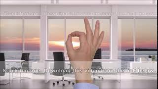 Businessman showing ok sign in modern office with sunset over the sea outside the window