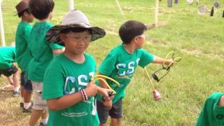 Justin Shooting Slingshot at Cub Scout Camp