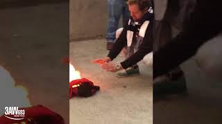 Bombers fan burns his scarf outside the MCG