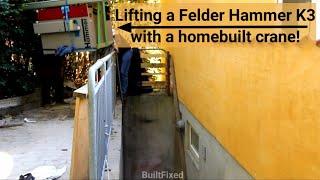 Lowering a Felder Hammer K3 table saw into a basement workshop