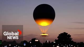 Olympic cauldron rises in hot-air balloon above Paris, delighting onlookers