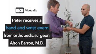 Peter receives a hand and wrist exam from orthopedic surgeon, Alton Barron, M.D.