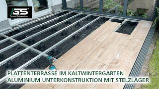 Terrasse mit Keramikplatten im Kaltwintergarten auf Stelzlager bauen