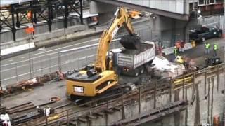 Cat 385CL Excavator loading trucks with heavy mud