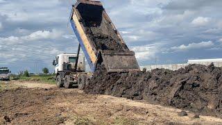 Incredible Dump Truck unloading dirt