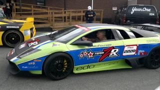 Lamborghini driving by a Ferrari during the 2011 Targa Newfoundland