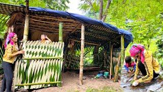 Mother and daughter use bamboo to make a kitchen, grow vegetables and make a windbreak for the hut.