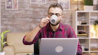 Freelancer Takes Sip Of Coffee Stock Video