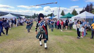 A mace flourish from Drum Major leading Towie Pipe Band march off at 2024 Aboyne Highland Games