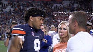 Bryan Harsin embraces Robby Ashford and family before leaving the field following 21-17 loss to LSU