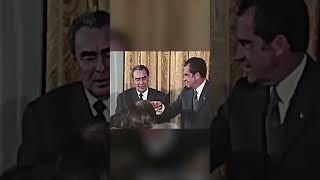 Soviet leader Leonid Brezhnev waits for President Nixon to drink champagne first