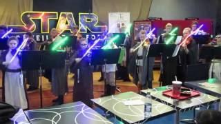 Children's orchestra plays the music from star wars on the violin use lightsabers