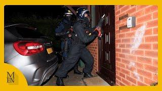 Shocking moment police smash in house during raids at dawn