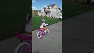 Lily riding her new princess bike.