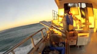 cray boat in surf, breakers and shallow waters