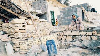 Strong hands of a pregnant mother: starting to build a platform with stones and cement