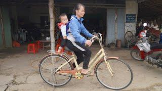 Single mother and her child dig the ground to make a road and buy a bicycle to carry goods