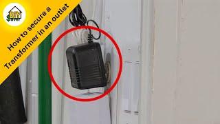 How to keep a transformer plug from falling out of an electrical wall socket