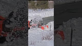 Kubota BX snow blowing snow bank