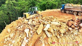 Amazing dump truck dumping rocks and machine bulldozer pushing rocks  building road mountains