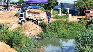 Wow! Great bulldozer and dump trucks filling up land over water