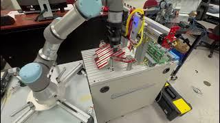 Integration of a TW Controls PLC trainer, an Amatrol Handling Station, and a Universal Robots Cobot