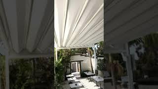 Retractable Fabric Pergola In Operation - Outdoor Cafe