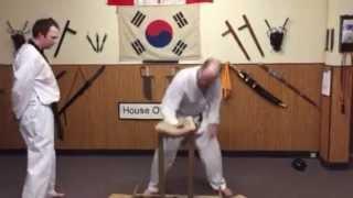 Grand Master Justin Powell With Student Pierre Kennedy Breaking His First Brick