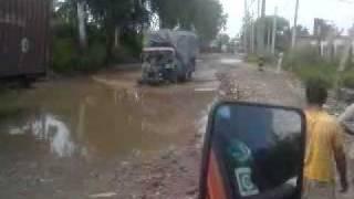 Tractor Wheelie: on water logged road (wow)