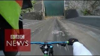 Biker films insane 60m bike dam drop in Slovenia  - BBC News