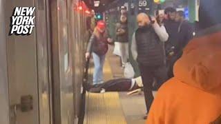 Straphanger drags unconscious man off NYC subway in wild video — to help get train moving