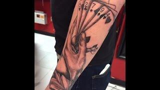 Hand holding playing cards tattoo