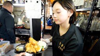 A pretty girl working hard! Men rush to the self-service diner to eat endless refills of food.