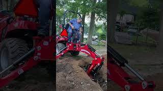 Massey Ferguson compact tractor  backhoe digging