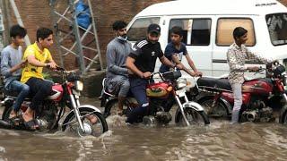 Traffic struggles through flooded road in Lahore, Pakistan after record rainfall | AFP