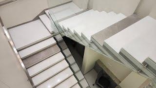 White marble flooring and staircase with railing design