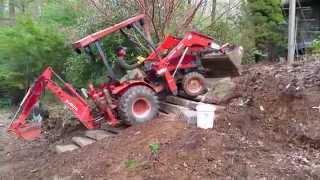 Kubota B21 Mini loader retaining wall and steps system of natural stone