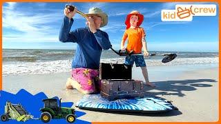 Finding buried treasure on beach with metal detector, tractors & ride on toys Educational | Kid Crew