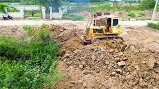 Amazing skill bulldozer operator pushing soil filling land and leveling roads