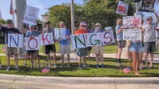 Protesters line the streets of Jacksonville's Southside to protest Donald Trump