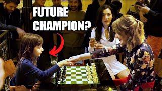 A little girl challenges a grandmaster at a chess bar in Paris