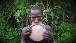 Surma tribe woman removing an putting her lip plate, Kibbish Ethiopia