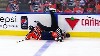 Linesman stretchered off after collision with McDavid