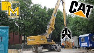 CAT 340 high reach demolition excavator tearing down storage building including changing boom