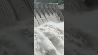 A large dam with a stream of water flowing over it