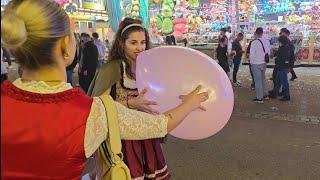 Girls have fun blowing up balloons too big in public (Preview Clip)