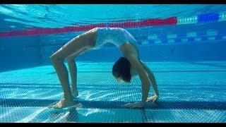 Carla underwater doing underwater gymnastics