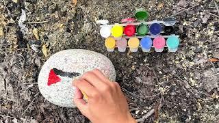 Korean tries to paint the Palestinian flag on a stone