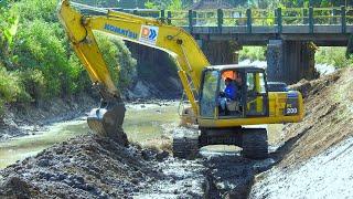 Excavator Trucks Working On River Bank Reinforcement Construction