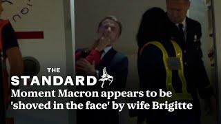 Watch: cameras capture moment President Macron appears to be shoved by wife Brigitte
